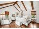 Bright bedroom featuring exposed beams, hardwood floors, and natural light from multiple windows at 1008 Delaney Park Dr, Orlando, FL 32806