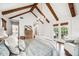 Bedroom with vaulted ceiling, exposed beams, and doorway to the bathroom at 1008 Delaney Park Dr, Orlando, FL 32806