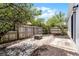 A backyard retreat featuring a stone patio, a fire pit, and a wooden fence at 103 Gleason Cv, Sanford, FL 32773