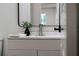 Modern bathroom with sleek vanity, mirror, and stylish decor at 103 Gleason Cv, Sanford, FL 32773