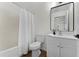 Bathroom featuring a tiled shower with white curtain, toilet, and vanity at 103 Gleason Cv, Sanford, FL 32773