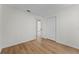 Minimalist bedroom with wood-look flooring, neutral walls, and a closet door at 103 Gleason Cv, Sanford, FL 32773