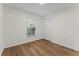 Bright bedroom with wood-look flooring and a window overlooking trees at 103 Gleason Cv, Sanford, FL 32773