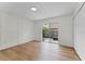 Spacious room with wood-look flooring and a sliding door to a small, fenced patio area at 103 Gleason Cv, Sanford, FL 32773