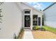 Close-up of a home's front entrance, featuring a black door with a wreath and inviting landscaping at 103 Gleason Cv, Sanford, FL 32773