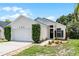 Charming single-story home with well-maintained landscaping and a two-car garage in a suburban neighborhood at 103 Gleason Cv, Sanford, FL 32773
