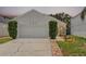 Single-story home with two-car garage, stone pathway, well-maintained lawn and mature landscaping at 103 Gleason Cv, Sanford, FL 32773