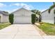 A well maintained one story home, with a clean 2 car garage and tidy, green landscaping and a blue sky at 103 Gleason Cv, Sanford, FL 32773