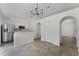 Bright kitchen features stainless steel appliances, white cabinetry, and arched doorway at 103 Gleason Cv, Sanford, FL 32773