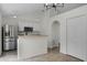 Bright kitchen features stainless steel appliances, white cabinetry, and modern lighting at 103 Gleason Cv, Sanford, FL 32773