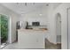 Bright kitchen features stainless steel appliances, white cabinetry, and breakfast bar at 103 Gleason Cv, Sanford, FL 32773