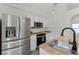Modern kitchen features stainless steel appliances, white cabinets, and butcher block countertops at 103 Gleason Cv, Sanford, FL 32773
