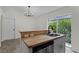 Kitchen sink with butcher block countertop, stainless steel dishwasher and view of backyard greenery at 103 Gleason Cv, Sanford, FL 32773