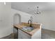 Kitchen with stainless steel dishwasher, butcher block counter and a view into the living room at 103 Gleason Cv, Sanford, FL 32773