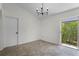 Living room with access to the lanai, tile flooring, and modern light fixture at 103 Gleason Cv, Sanford, FL 32773