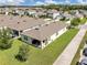 Rear aerial view of the home, showing its backyard, covered patio, and proximity to neighborhood streets at 115 Duchess Rd, Deland, FL 32724