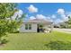 Well-maintained backyard with lush green lawn, covered patio, perfect for outdoor gatherings at 115 Duchess Rd, Deland, FL 32724
