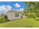 Manicured lawn and covered patio provide a tranquil backyard retreat at 115 Duchess Rd, Deland, FL 32724