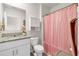 Well lit bathroom includes a granite countertop, a vanity and toilet, and a shower with curtain at 115 Duchess Rd, Deland, FL 32724