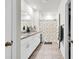 Bright bathroom featuring double sinks, granite countertops, and a shower with a decorative curtain at 115 Duchess Rd, Deland, FL 32724