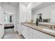 Bathroom featuring double sinks with granite countertops and a view into the adjacent bedroom at 115 Duchess Rd, Deland, FL 32724