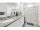 Bright bathroom features a granite countertop vanity with dual sinks, and a shower with decorative curtain at 115 Duchess Rd, Deland, FL 32724