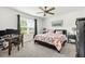 Comfortable bedroom with a floral-patterned bed, desk area, and ample natural light from the window at 115 Duchess Rd, Deland, FL 32724