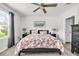 Inviting bedroom with a floral comforter, bedside tables, and a bright window view at 115 Duchess Rd, Deland, FL 32724
