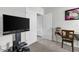 Comfortable bedroom features a modern desk, TV, and two doors offering easy access to other areas of the home at 115 Duchess Rd, Deland, FL 32724