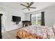 Bedroom has a ceiling fan, large window, and desk, perfect for a home office or a comfortable retreat at 115 Duchess Rd, Deland, FL 32724