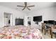 Spacious bedroom featuring a floral-patterned bed, desk setup, and convenient access to the bathroom at 115 Duchess Rd, Deland, FL 32724