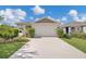 Charming single-story home boasts a well-maintained lawn and attached two-car garage, enhancing its curb appeal at 115 Duchess Rd, Deland, FL 32724