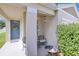 Inviting front porch featuring a cozy seating area, decorative wreath, and lush landscaping, creating a warm welcome at 115 Duchess Rd, Deland, FL 32724
