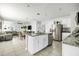 Spacious open-concept kitchen with island, stainless steel appliances, white cabinets, and adjoining living and dining areas at 115 Duchess Rd, Deland, FL 32724