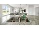 Kitchen island featuring granite countertops, stainless steel sink and fixtures, with open view to living room at 115 Duchess Rd, Deland, FL 32724