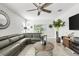 Cozy living room featuring a large sectional sofa, stylish decor, and access to the outdoor space at 115 Duchess Rd, Deland, FL 32724