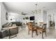 Inviting living room and dining area with contemporary furnishings, including a large sofa and stylish chandelier at 115 Duchess Rd, Deland, FL 32724
