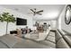 Open-concept living room featuring modern decor, large sectional sofa, and seamless flow to the kitchen at 115 Duchess Rd, Deland, FL 32724