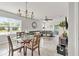Bright living room with dining area, featuring a comfortable sectional sofa and natural light from large windows at 115 Duchess Rd, Deland, FL 32724