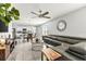 Well-lit living area with a modern sectional sofa, adjacent to an open-plan kitchen and dining space at 115 Duchess Rd, Deland, FL 32724