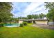 A backyard featuring a pristine pool, attached garage, and a charming, single-story home at 1171 Covewood Trl, Maitland, FL 32751