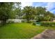 Spacious backyard with lush greenery, a white fence, and a refreshing swimming pool at 1171 Covewood Trl, Maitland, FL 32751