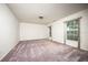 Bright bedroom with neutral walls, carpet floors, and large windows offering ample natural light at 1171 Covewood Trl, Maitland, FL 32751