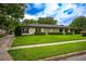 Classic single-story home with a lush lawn and mature trees, showcasing its curb appeal at 1171 Covewood Trl, Maitland, FL 32751