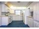 Well-lit kitchen featuring white cabinetry, essential appliances, and a unique, eye-catching floor at 1171 Covewood Trl, Maitland, FL 32751