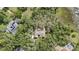 Aerial view of a home nestled among trees with a view of a lake at 137 Hickory Ridge Cir, Lake Mary, FL 32746