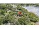 Aerial view featuring the roof with surrounding mature trees and a lake in the distance at 137 Hickory Ridge Cir, Lake Mary, FL 32746