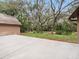 Spacious concrete patio overlooking a lush backyard with mature trees at 137 Hickory Ridge Cir, Lake Mary, FL 32746