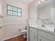 Cozy bathroom featuring a single sink vanity, tile floors and patterned wallpaper at 137 Hickory Ridge Cir, Lake Mary, FL 32746