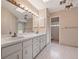 Bathroom featuring a double vanity, wallpaper, and a skylight for natural light at 137 Hickory Ridge Cir, Lake Mary, FL 32746